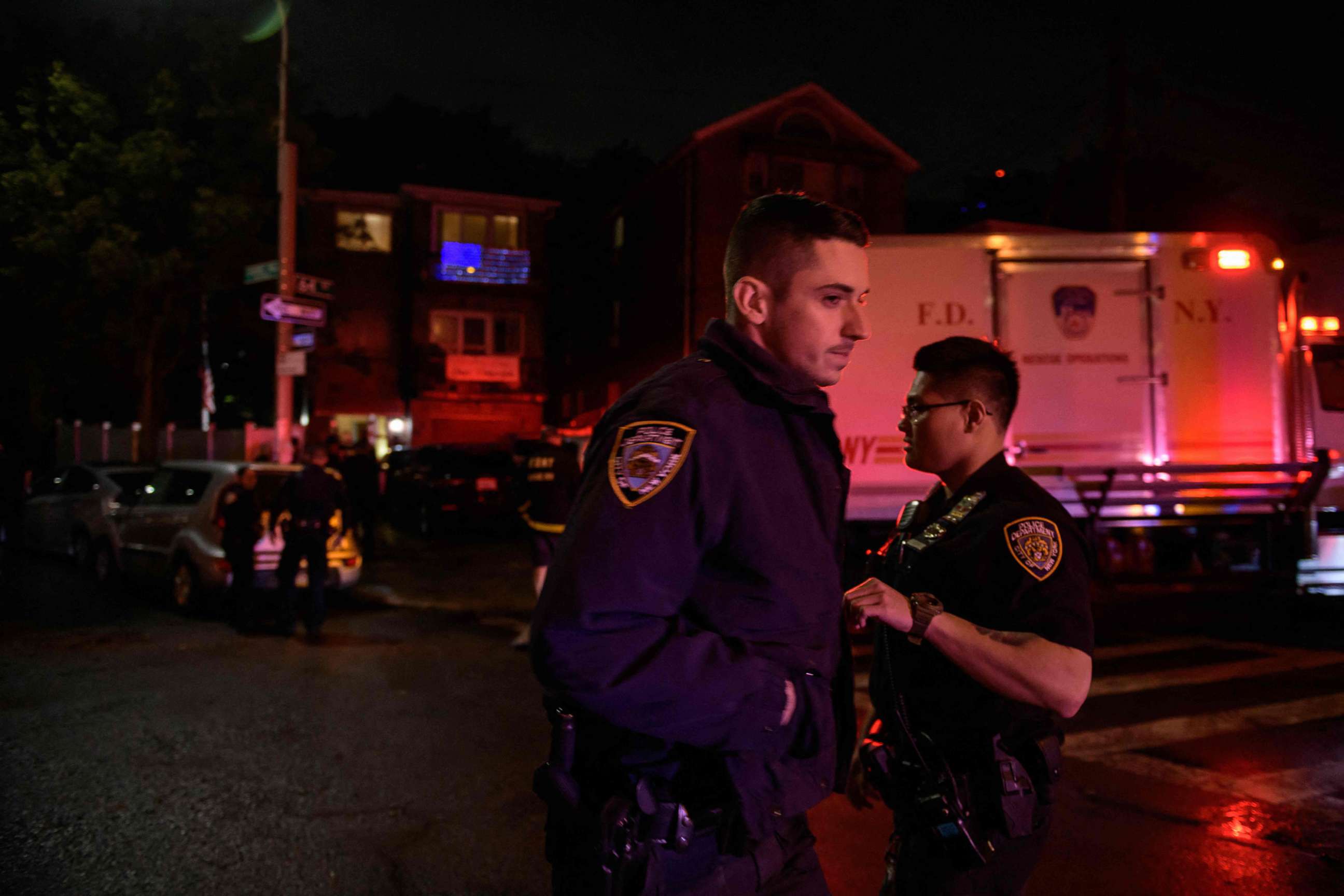 PHOTO: Police officers and rescue workers gather outside a house where people were trapped in a flooded basement in Queens, New York, early on Sept. 2, 2021.