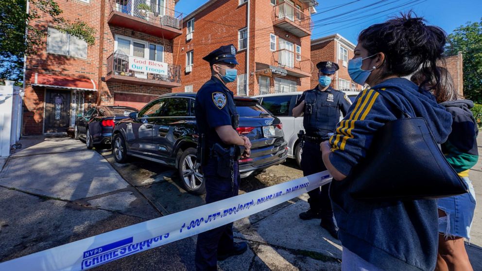 PHOTO: Deborah Torres, right, talks to police officers standing outside her home in the Queens borough of New York where three people died when their basement apartment flooded, Sept. 2, 2021.