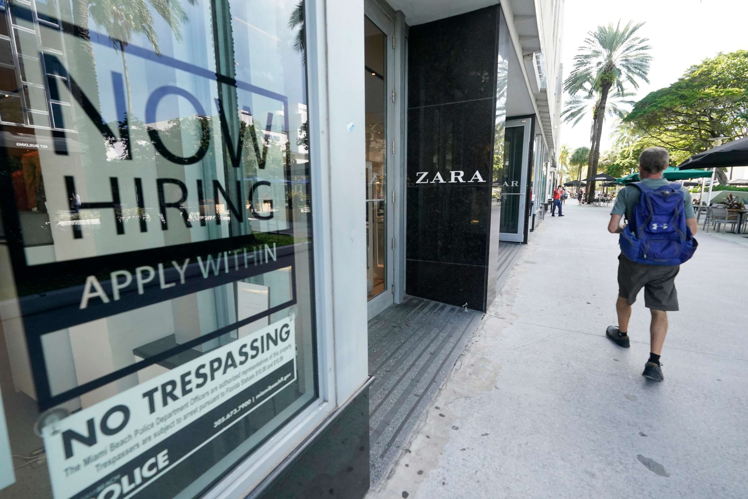 PHOTO: A pedestrian walks past a Zara store with a large "Now Hiring," sign in the window, Oct. 12, 2020, along the famed Lincoln Road area in Miami Beach, Fla.