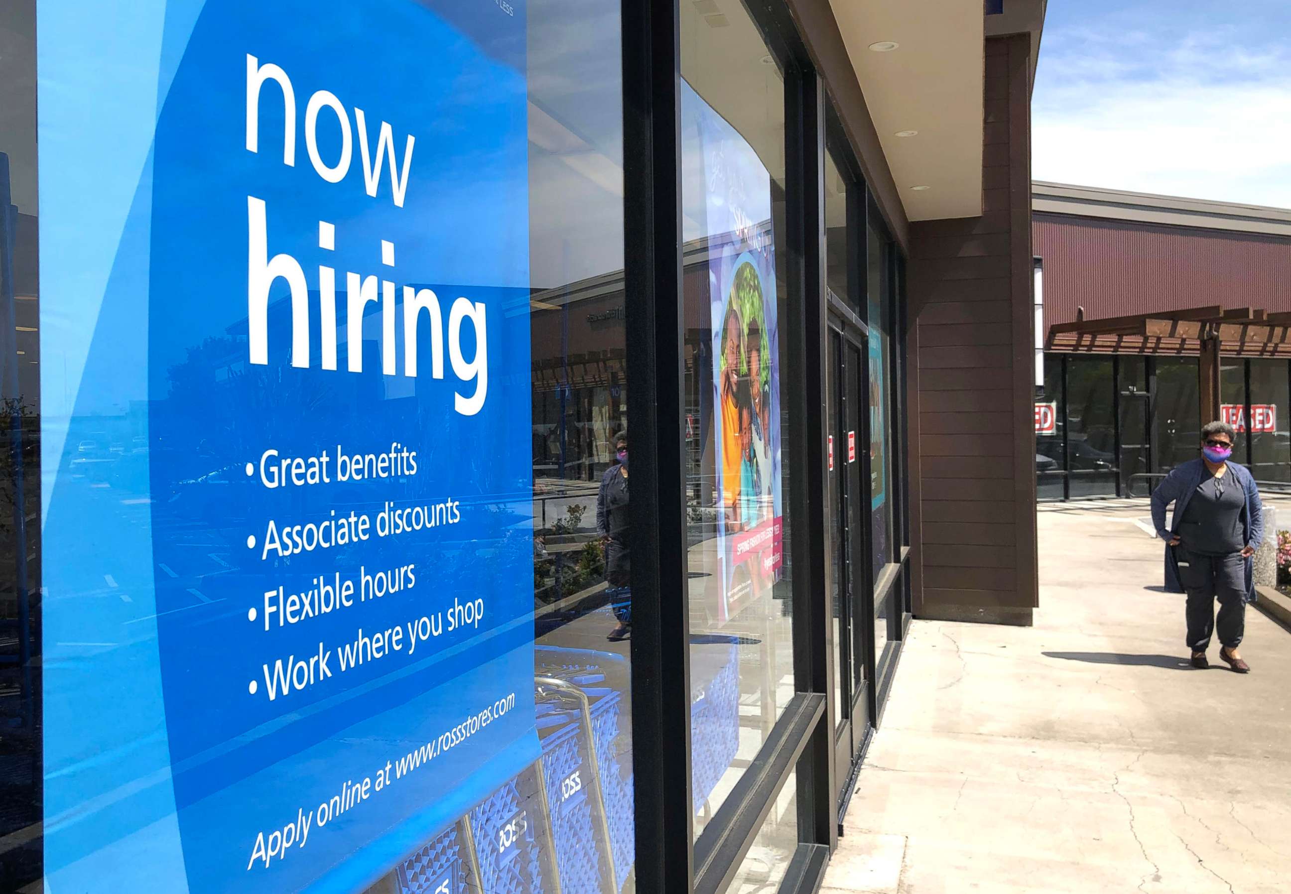 PHOTO: In this April 2, 2021, file photo, a pedestrian walks by a now hiring sign at a store in San Rafael, Calif.