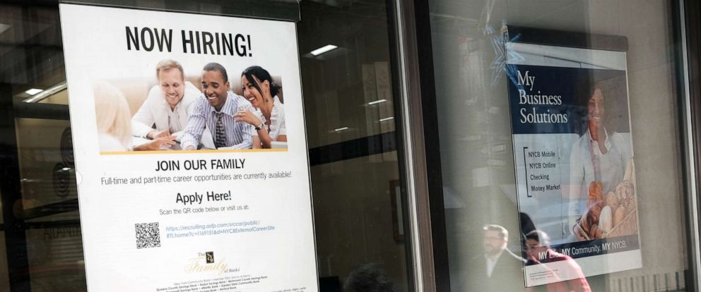 PHOTO: A now hiring sign is displayed in a window of a store on Dec. 2, 2022, in New York.