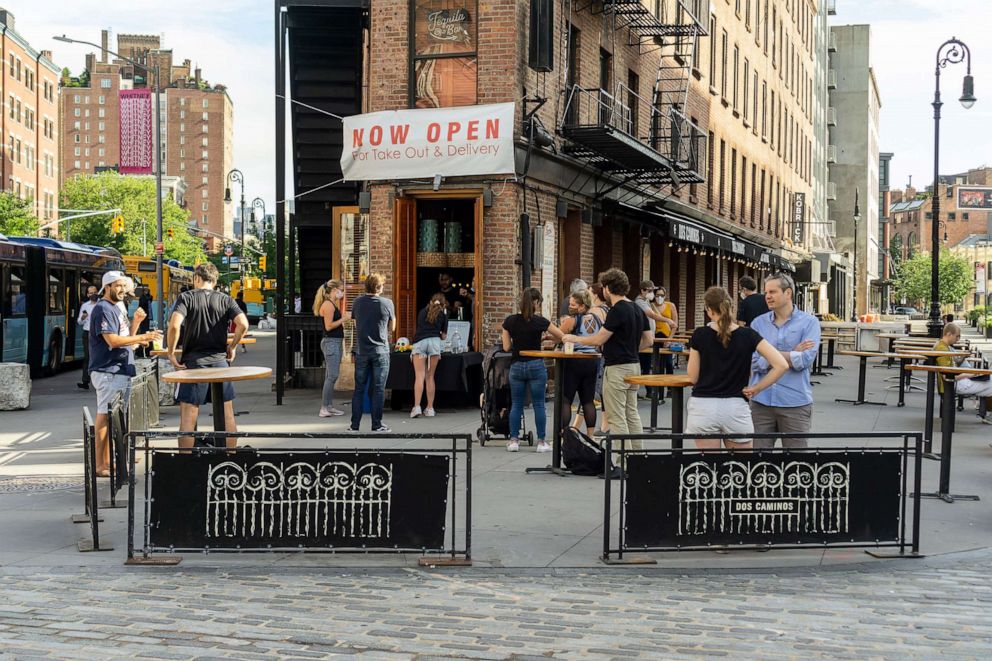 PHOTO: Customers have cocktails outside a restaurant in the Meatpacking District in New York, June 18, 2020. 