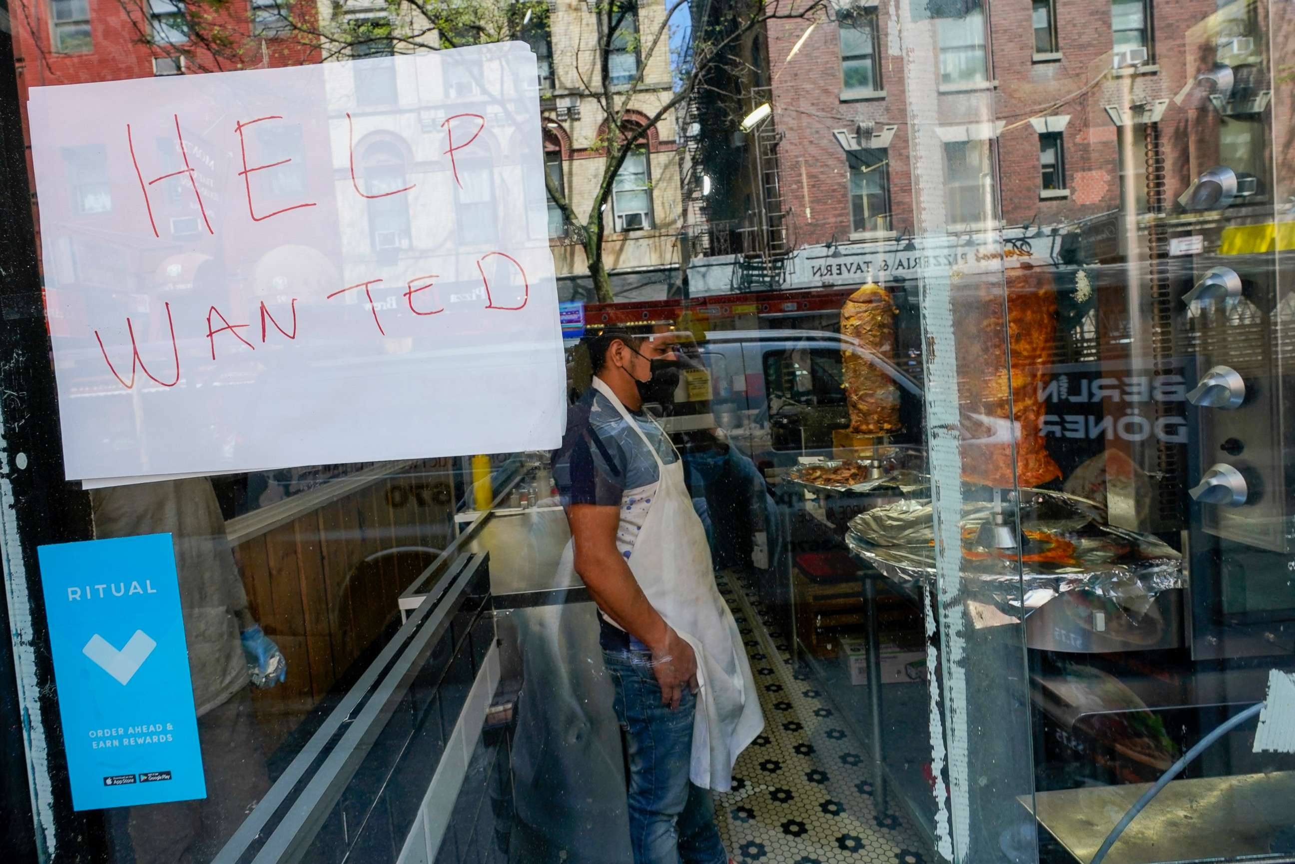 PHOTO: A Help Wanted sign hangs in the window of a restaurant in the Greenwich Village neighborhood of Manhattan in New York City, May 4, 2021.