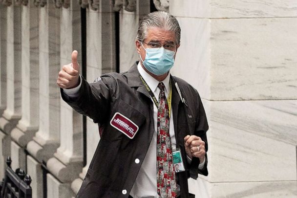 PHOTO: Trader Daniel Krieger signals a thumbs-up as he arrives at the New York Stock Exchange where the trading floor reopens, May 26, 2020.