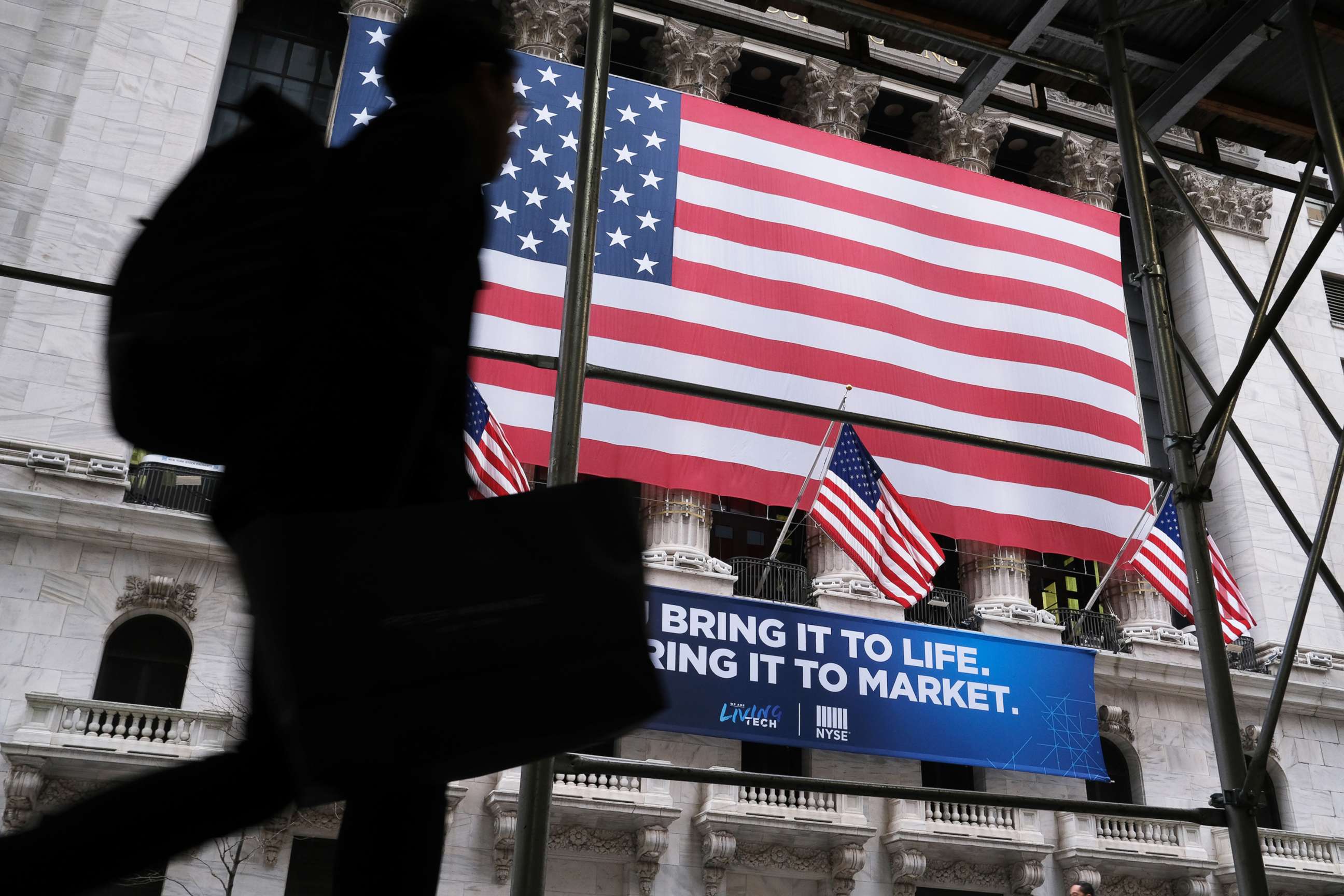 PHOTO: People walk past the New York Stock Exchange (NYSE), Feb. 12, 2020, in New York.