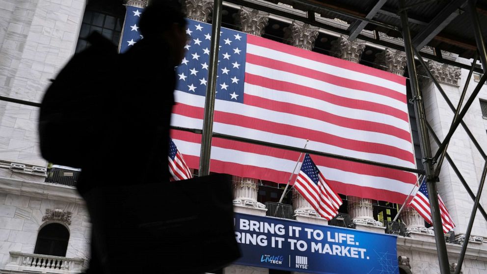 PHOTO: People walk past the New York Stock Exchange (NYSE), Feb. 12, 2020, in New York.