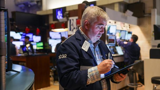 Traders work on the floor of the New York Stock Exchange (NYSE) on May 21, 2025 in New York City.