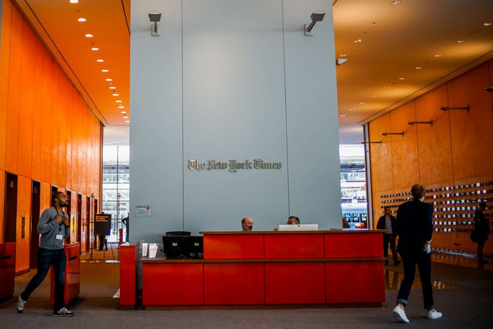 PHOTO: People walk inside the New York Times building, Oct. 14, 2019, in New York City. 