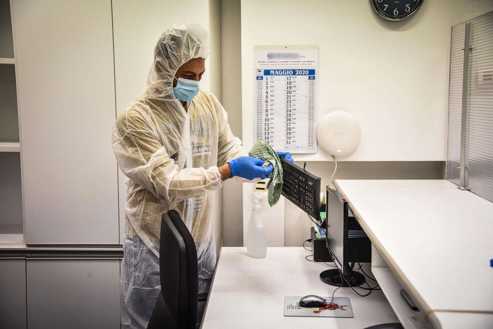 PHOTO: A worker wearing protective gear disinfects an office prior to its reopening amid the ongoing coronavirus COVID-19 pandemic in Milan, Italy, May 2, 2020.