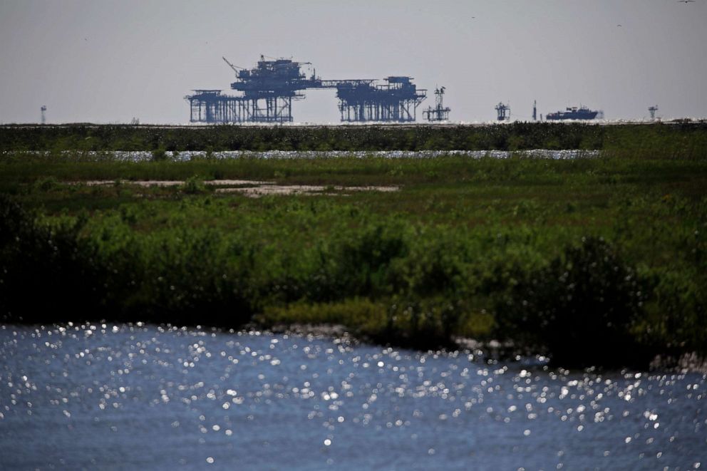 PHOTO: Offshore oil well platforms in the Gulf of Mexico off Port Fourchon, La., April 21, 2021. 