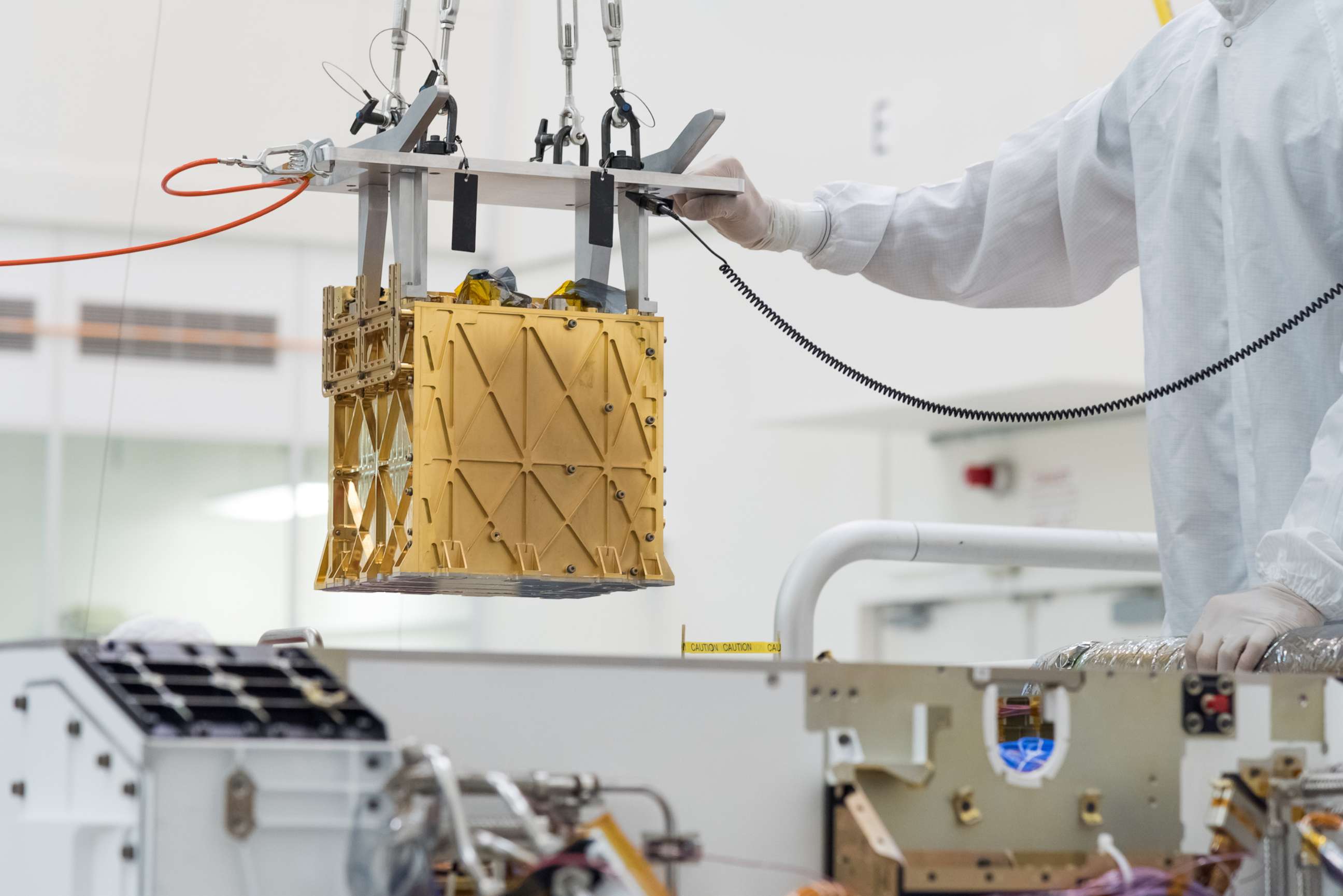 PHOTO: The Mars Oxygen In-Situ Resource Utilization Experiment (MOXIE) instrument is lowered into the Perseverance rover, March 21, 2019 at NASA's Jet Propulsion Laboratory, in Pasadena, Calif.