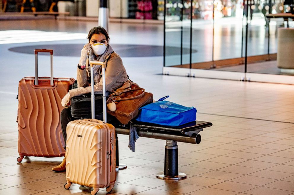 PHOTO: A woman wears a face mask while wait at Schiphol airport, in Netherlands, April 19, 2020. 