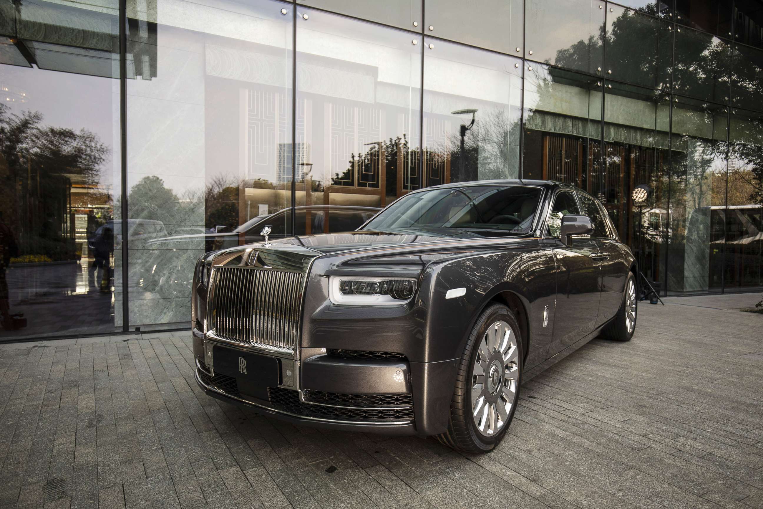 PHOTO: A Rolls-Royce Motor Cars Ltd. Phantom automobile sits on display in front of the Mandarin Oriental Hotel in Shanghai, China, March 20, 2019. 