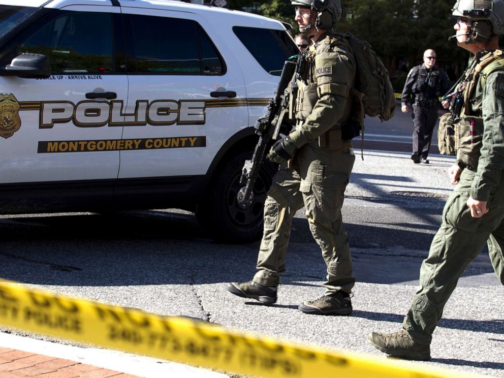PHOTO: Montgomery police officers in tactical gear exit a parking garage where a police officer was shot, in Silver Spring, Md., Oct. 14, 2019.