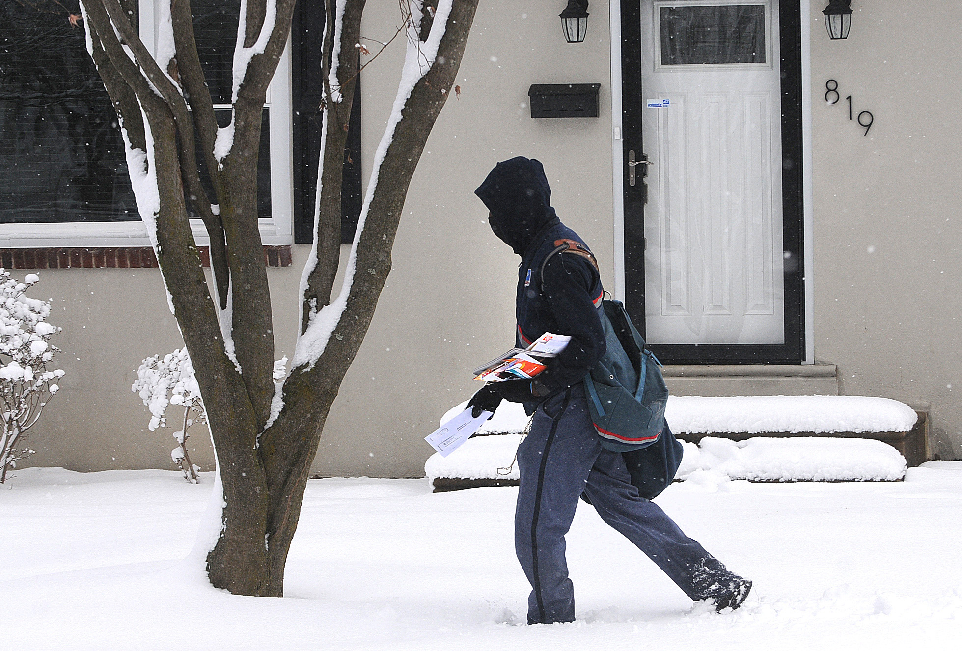 PHOTO: A postal worker delivers mail along Homestead Ave. in Springfield, Pa., Feb. 2, 2021.