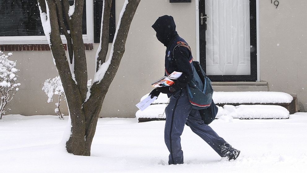 PHOTO: A postal worker delivers mail along Homestead Ave. in Springfield, Pa., Feb. 2, 2021.