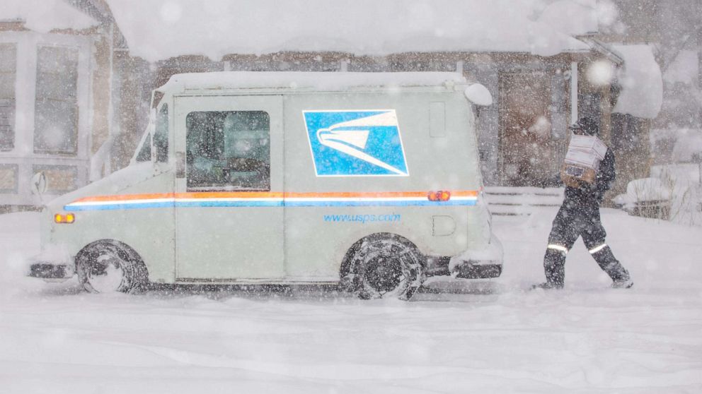 PHOTO: A United States Postal Service worker delivers mail in the snow in Flagstaff on Jan. 25, 2021.Jan 25 2021 Flagstaff Snow Day
