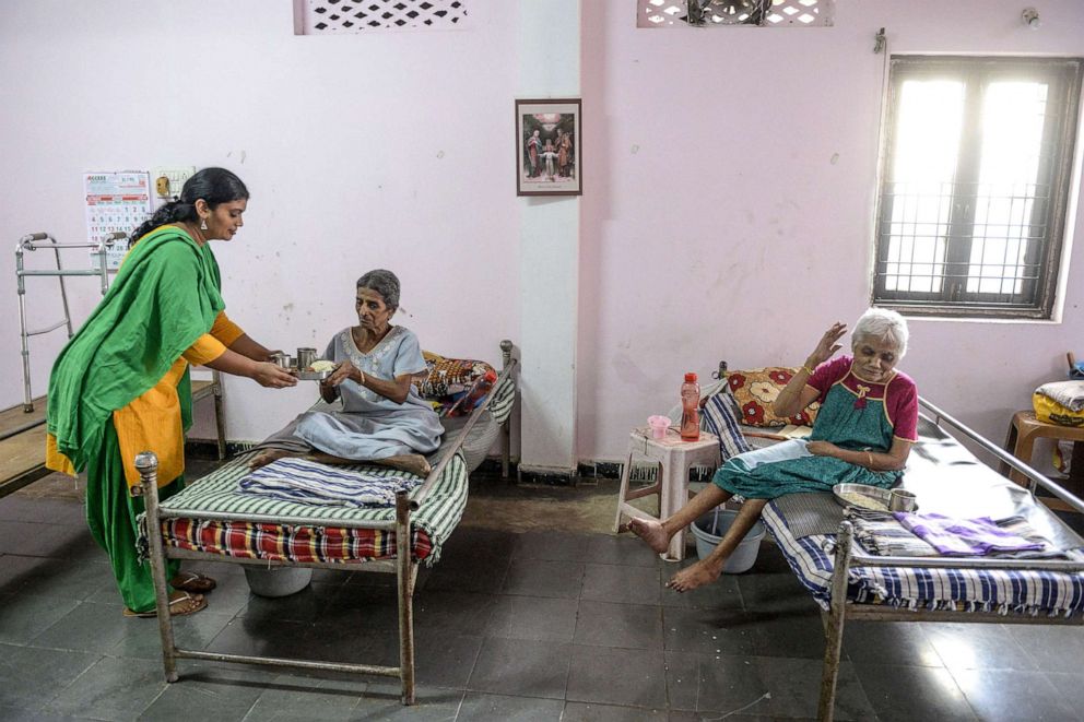 PHOTO: A caretaker serves food to residents at Saint Joseph home care for the elderly   in Hyderabad, Oct. 1, 2020.