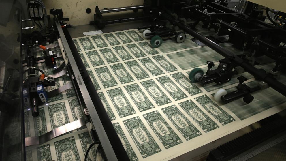 PHOTO: In this March 24, 2015, file photo, sheets of one dollar bills run through the printing press at the Bureau of Engraving and Printing in Washington, D.C. 