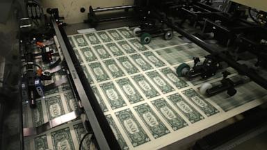 PHOTO: In this March 24, 2015, file photo, sheets of one dollar bills run through the printing press at the Bureau of Engraving and Printing in Washington, D.C. 