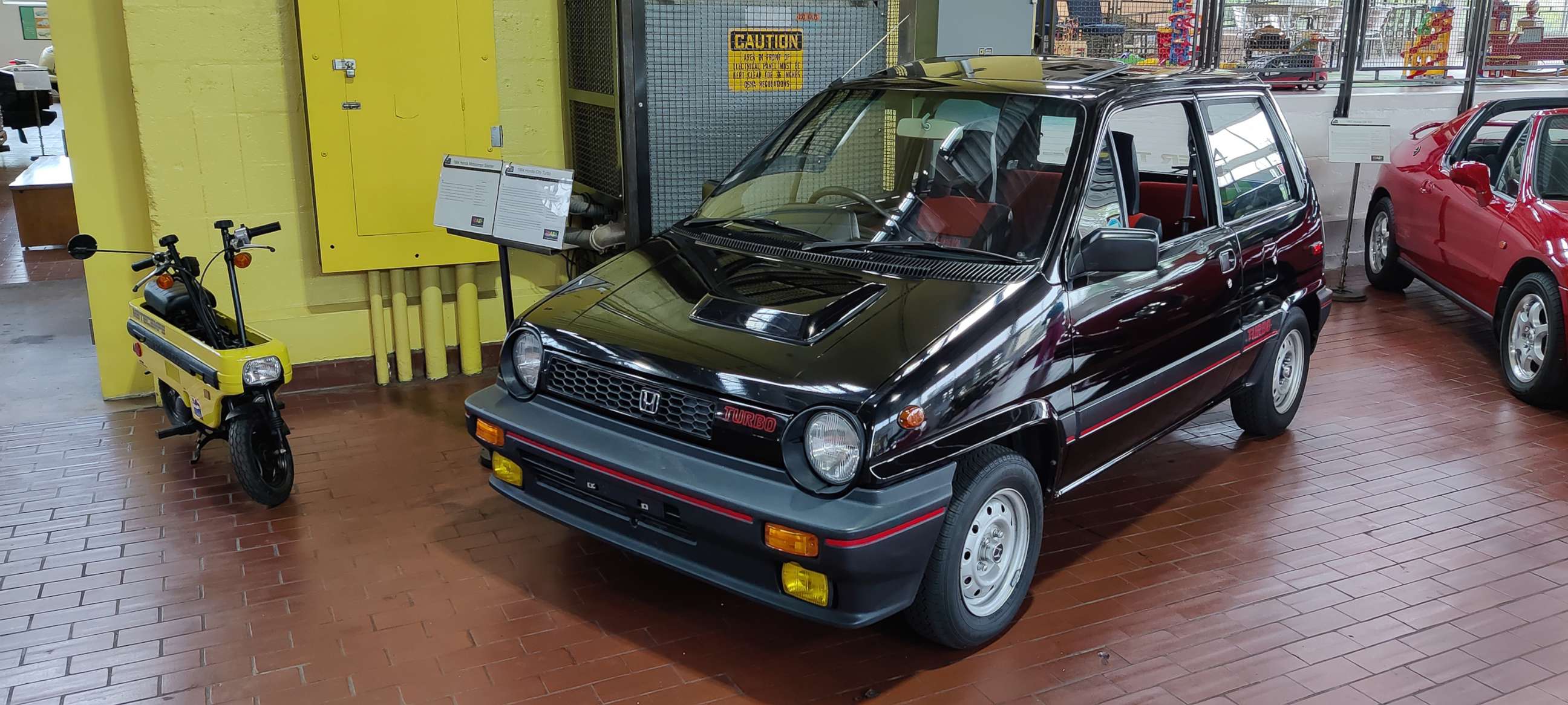 PHOTO: A 1984 Honda City Turbo, with accompanying "Motocompo" scooter, displayed at the Radwood exhibit at the Lane Motor Museum in Nashville, Ky., August 2021.