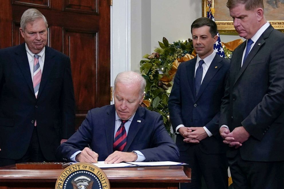 PHOTO: President Joe Biden signs H.J.Res.100, a bill that aims to avert a freight rail strike, in the Roosevelt Room at the White House, Dec. 2, 2022.