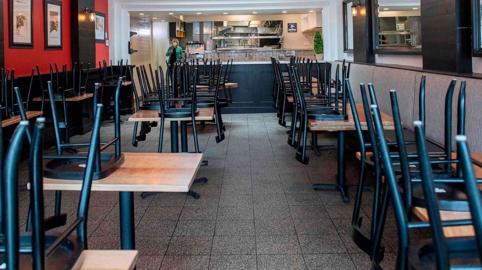 PHOTO: Chairs are stacked on tables in the empty dining room of Maria's Italian Kitchen now closed due to the Covid-19 pandemic, July 28, 2020, in Santa Monica, Calif.