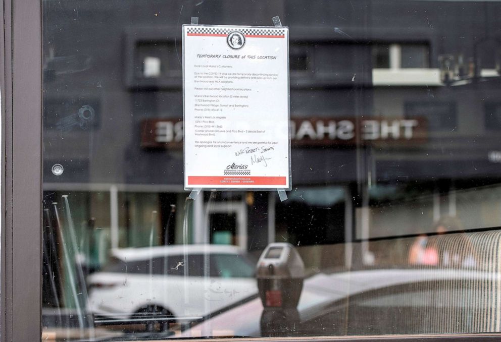 PHOTO: A sign is seen on Maria's Italian Kitchen Santa Monica warning the consumers that the restaurant is closed due to Covid 19 pandemic, July 28, 2020, in Santa Monica, Calif.