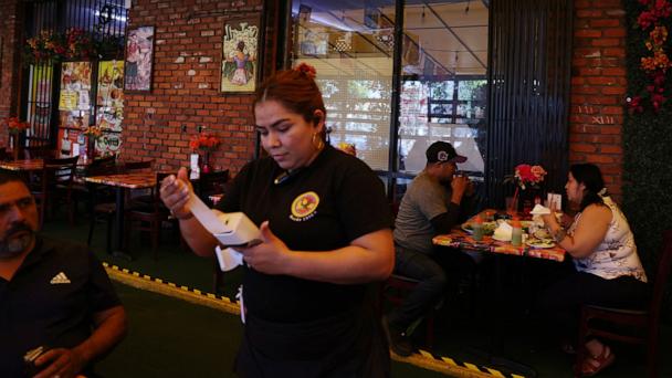 People eat at a Mexican restaurant in Los Angeles, June 17, 2025. 