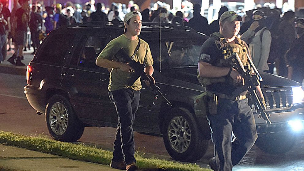 PHOTO: Kyle Rittenhouse, center, with cap on backwards, walks along Sheridan Road in Kenosha, Wis., Aug. 25, 2020, with another armed civilian.