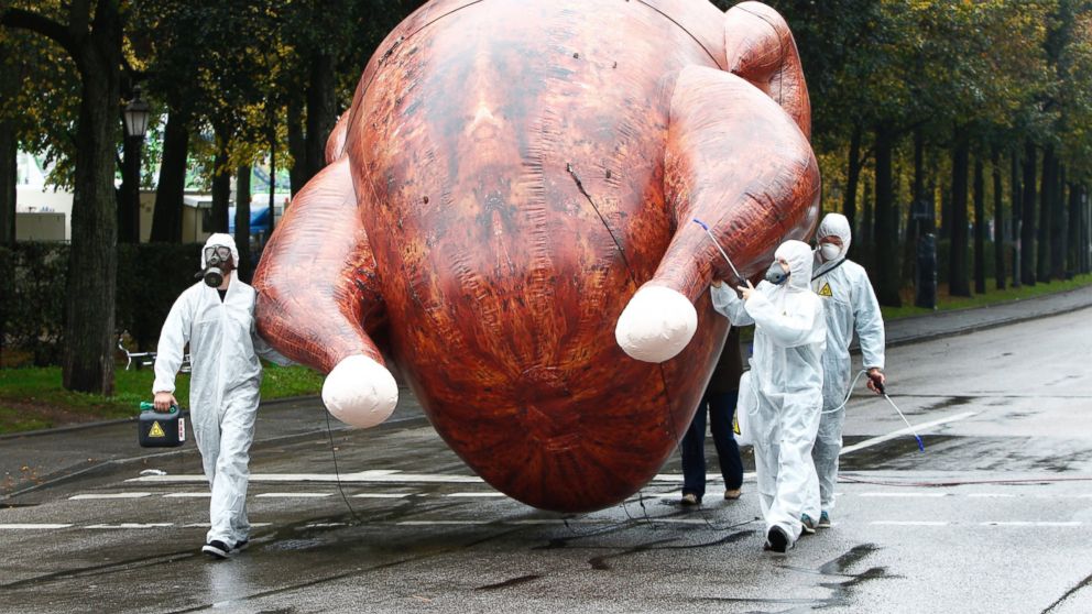 Environmental activists carry a giant inflatable chicken as they demonstrate against "chlorine chickens" near the Oktoberfest grounds in Munich, Oct. 1, 2014.