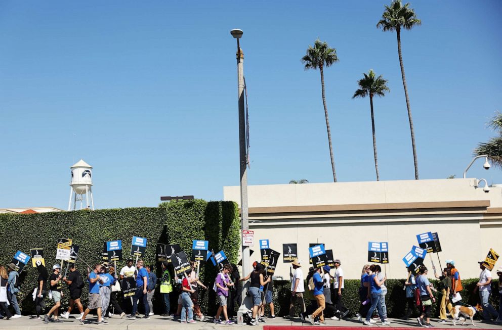 PHOTO: Striking SAG-AFTRA members picket as WGA (Writers Guild of America) members march in solidarity outside Paramount Studios on October 02, 2023 in Los Angeles, California.