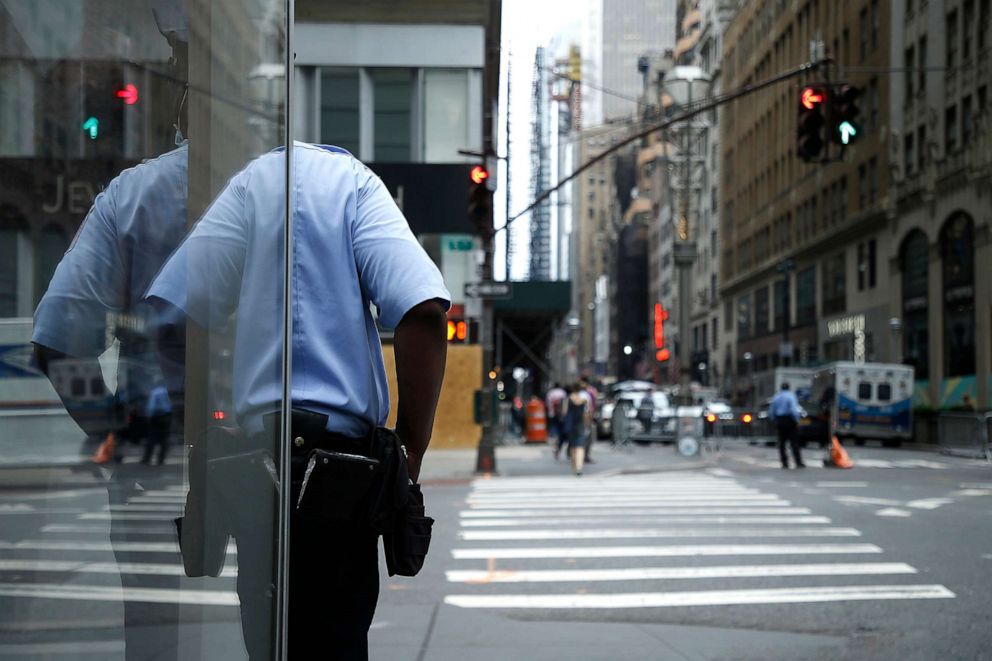PHOTO: A security guard stands next to a retail store in New York City on June 11, 2020.