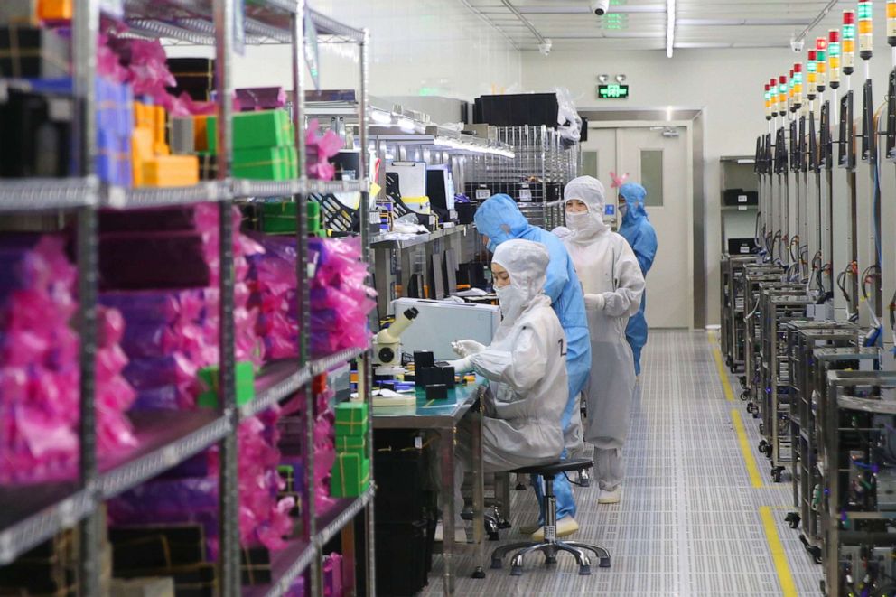 PHOTO: Employees work on the production line of silicon wafer at a factory of GalaxyCore Inc. on May 25, 2021, in Jiaxing City, Zhejiang Province, China.