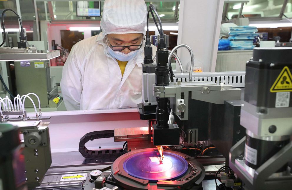 PHOTO: Employees work on the production line for silicon wafers at a workshop of Jiejie Semiconductor Co., Ltd on March 17, 2021, in Nantong, Jiangsu Province of China.