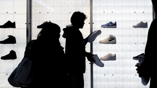 People shop for shoes in a Nike store on Nov. 25, 2022, in New York.