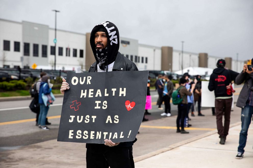 PHOTO: Chris Smalls, a fired Amazon fulfillment center employee, holds a sign during a protest outside an Amazon facility in the Staten Island borough of New York, May 1, 2020.