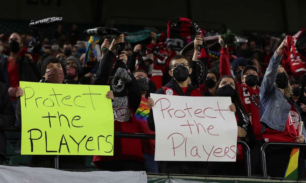 PHOTO: Portland Thorns fans hold signs during the first half of the team's NWSL soccer match against the Houston Dash in Portland, Ore., Oct. 6, 2021.