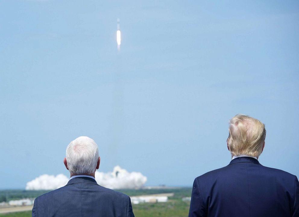 PHOTO: Vice President Mike Pence and President Donald Trump watch as the SpaceX Falcon 9 rocket carrying the SpaceX Crew Dragon capsule, with astronauts Bob Behnken and Doug Hurley, lifts off from Kennedy Space Center in Florida on May 30, 2020.