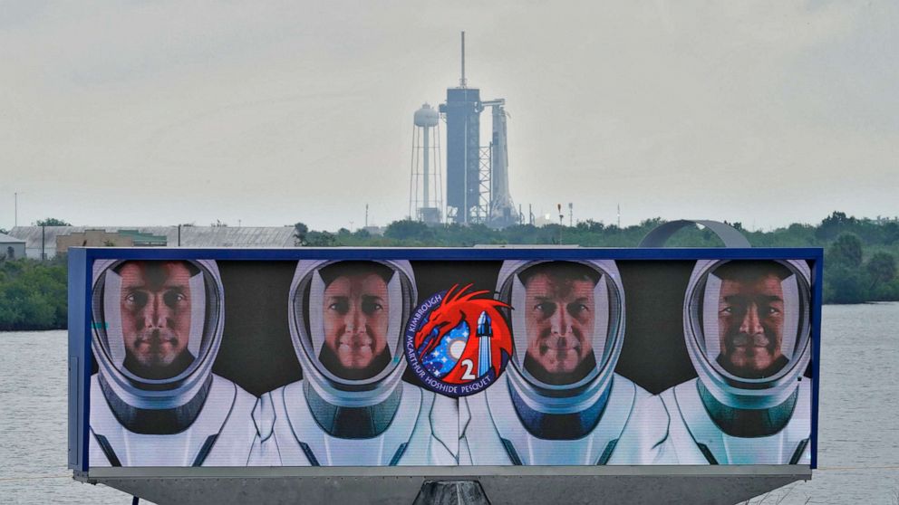 PHOTO: Members of the SpaceX Crew 2 are shown on a video screen as the SpaceX Falcon 9 with the crew Dragon capsule sits on Launch Complex 39A, April 21, 2021, at the Kennedy Space Center in Cape Canaveral, Fla.