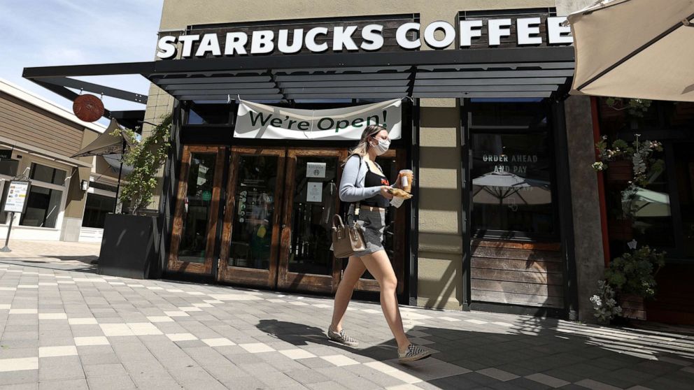 PHOTO: A customer walks by a Starbucks Coffee store, June 10, 2020, in Corte Madera, Calif.