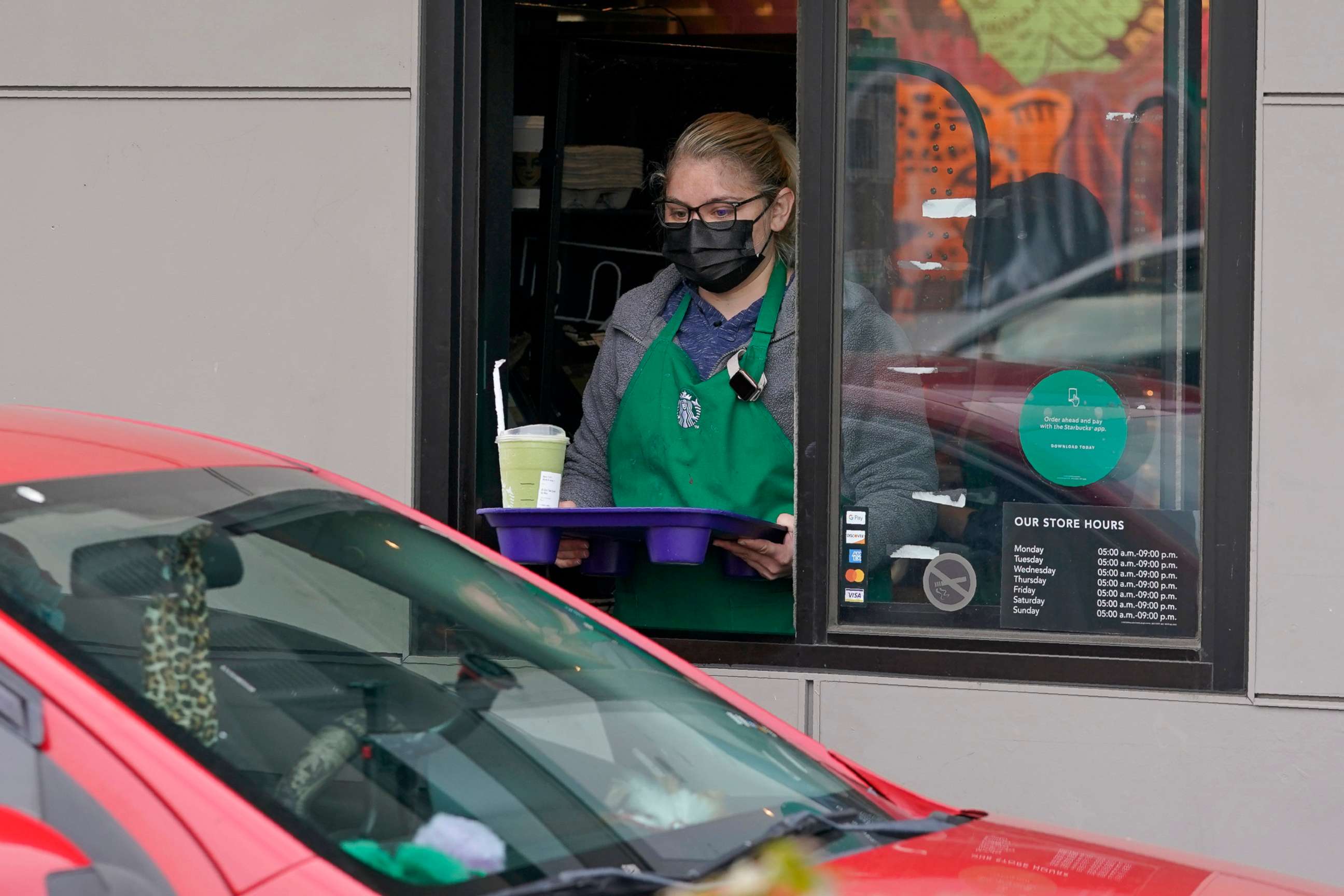 PHOTO: In this Oct. 27, 2020, file photo, a barista serves up a drink in the drive-through lane at a Starbucks Coffee store in south Seattle.