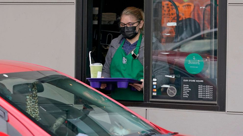 PHOTO: In this Oct. 27, 2020, file photo, a barista serves up a drink in the drive-through lane at a Starbucks Coffee store in south Seattle.