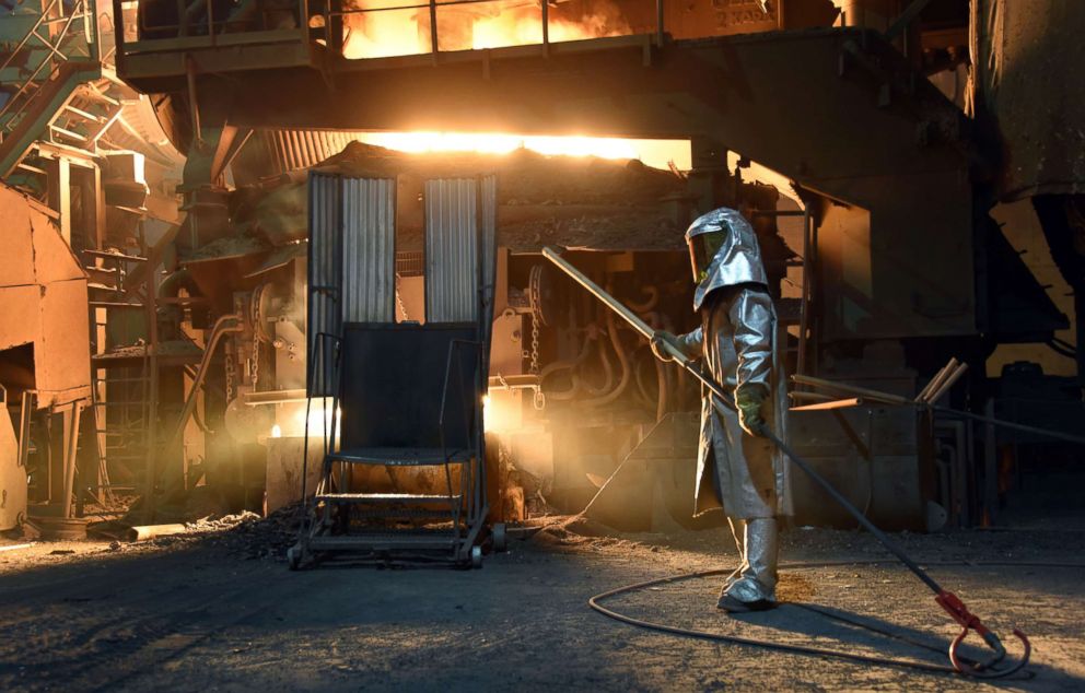PHOTO: A steelworker in a protective suit checks the temperature of molten metal in furnace at the TMK Ipsco Koppel plant in Koppel, Pa., March 9, 2018.