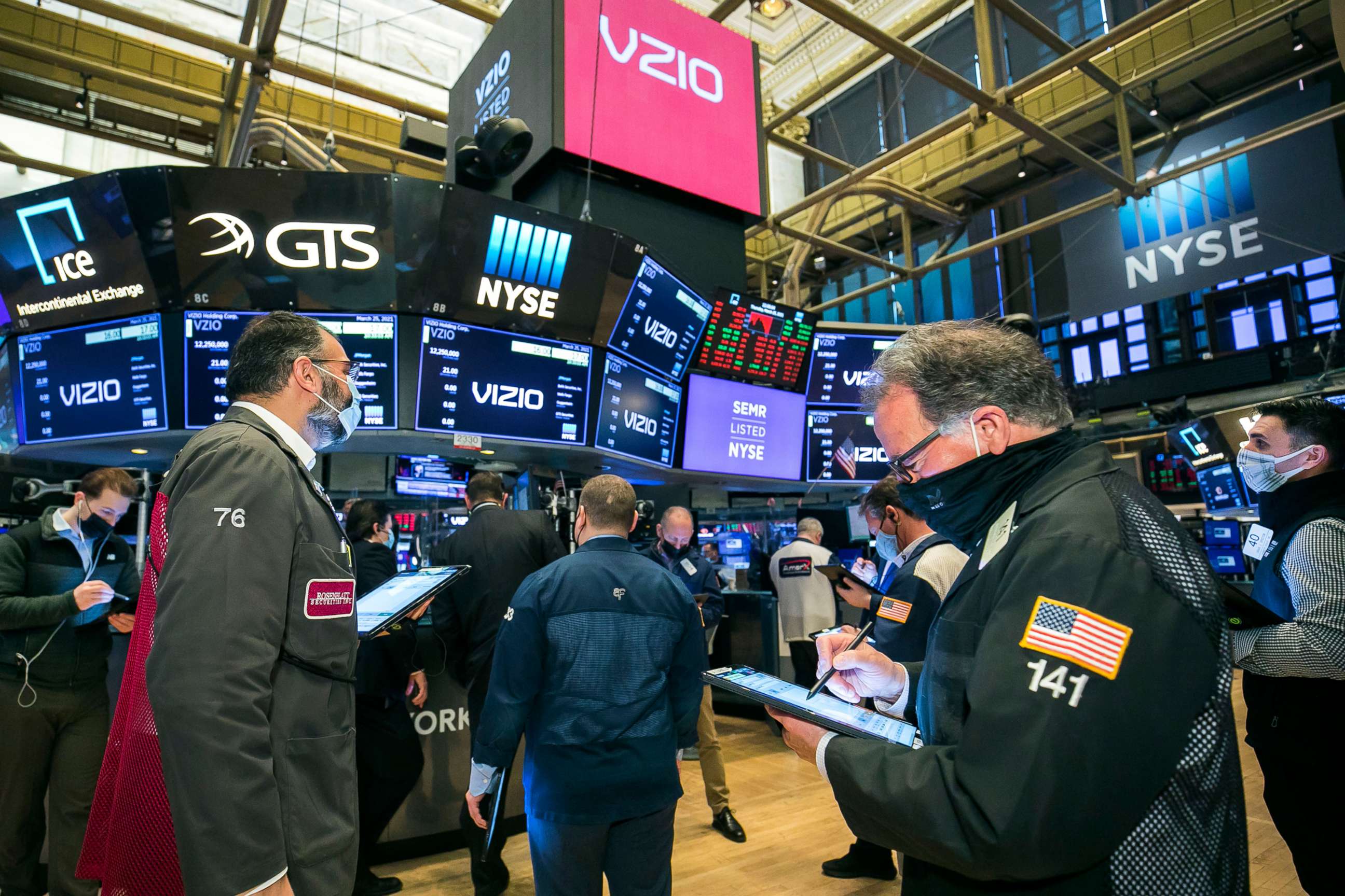 PHOTO: In this photo provided by the New York Stock Exchange, traders gather on the floor on March 25, 2021, in New York.