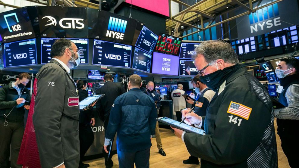 PHOTO: In this photo provided by the New York Stock Exchange, traders gather on the floor on March 25, 2021, in New York.