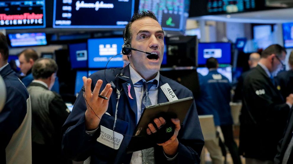 PHOTO: Traders work on the floor of the New York Stock Exchange in New York, March 20, 2020.