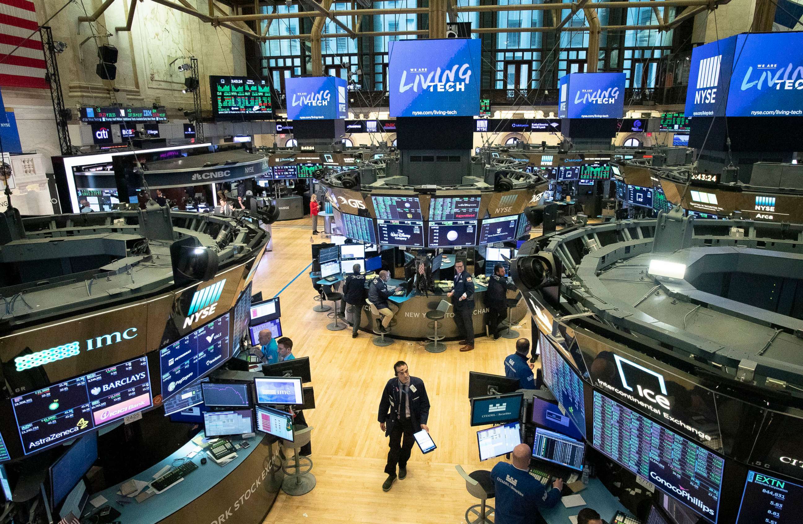 PHOTO: A trader walks on the floor of the New York Stock Exchange during President Donald Trump's televised speech from the White House, in New York, March 13, 2020.