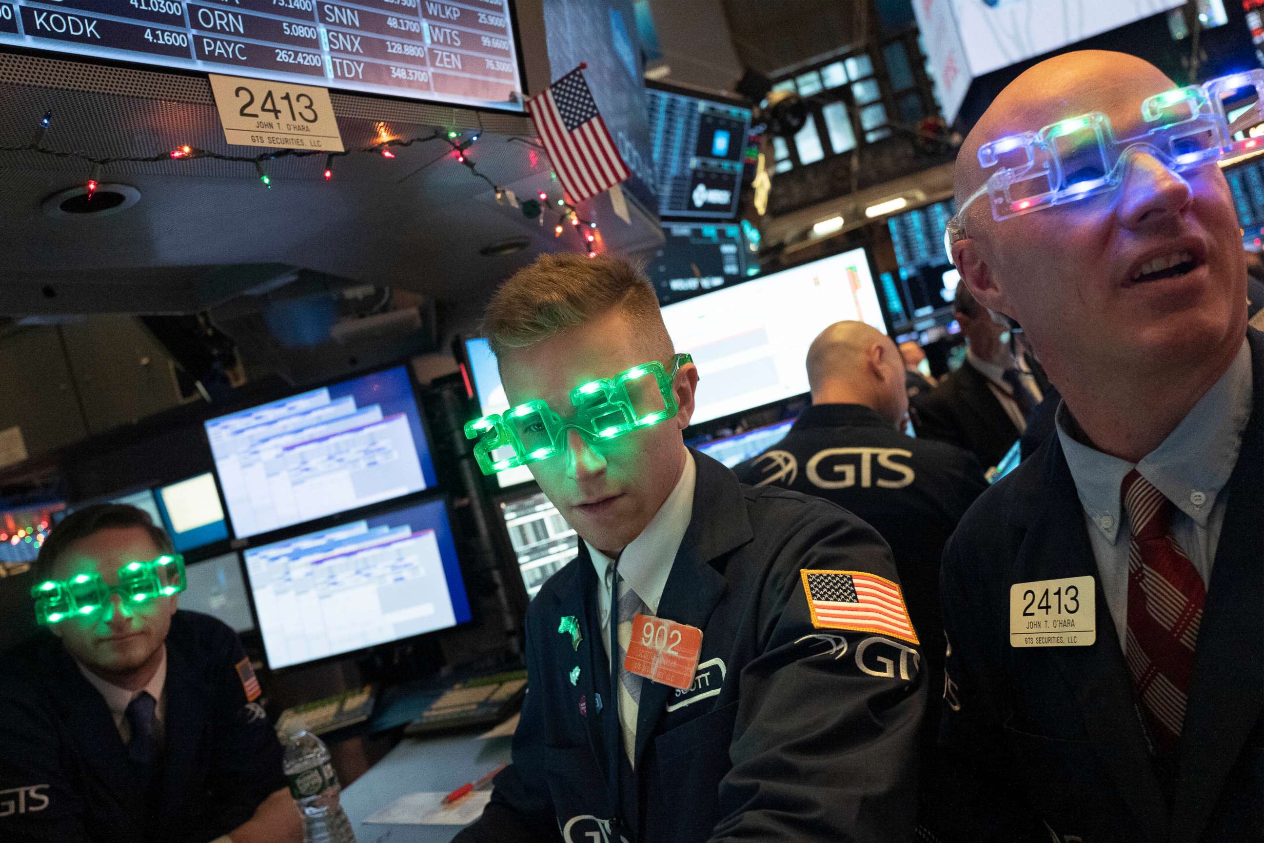 PHOTO: Stock traders wear New Year's 2020 party glasses at the New York Stock Exchange, Tuesday, Dec. 31, 2019. Wall Street could close 2019 with back-to-back daily losses in a year that the U.S. posted the largest market gains since 2013.