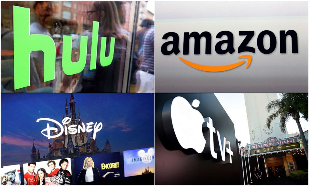PHOTO: This combination photo shows the Hulu logo on a window in New York, the Amazon logo in Santa Monica, Calif., the Apple TV+ logo in Los Angeles and a screen grab of the Disney Plus streaming service on a computer screen.